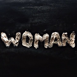 Cover von The King's Parade; Das Wort "Woman" auf eine schwarze Oberfläche gepinselt